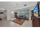 Bright living room features tile flooring, a large window, and modern furniture at 24312 Westgate Blvd, Port Charlotte, FL 33980
