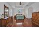 Spacious primary bedroom with tray ceiling, wood floors, ensuite bath, and closet at 24312 Westgate Blvd, Port Charlotte, FL 33980