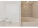 Bathroom features neutral walls, neutral tile floors, and a soaking tub with shower at 3129 Buttonwood Pl, Punta Gorda, FL 33950