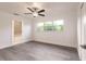 Bedroom featuring neutral walls, grey wood floors, large windows and a ceiling fan at 3129 Buttonwood Pl, Punta Gorda, FL 33950
