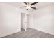A bright bedroom with gray wood flooring features white walls, ceilings, trim, and doors at 3129 Buttonwood Pl, Punta Gorda, FL 33950