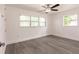 Bright bedroom with gray wood flooring and a ceiling fan; exterior view of the surrounding area at 3129 Buttonwood Pl, Punta Gorda, FL 33950
