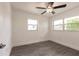 Bright bedroom with modern gray wood flooring and a ceiling fan with attached light fixture at 3129 Buttonwood Pl, Punta Gorda, FL 33950