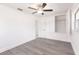 Bright bedroom with gray wood flooring, white walls, a ceiling fan, and a closet at 3129 Buttonwood Pl, Punta Gorda, FL 33950