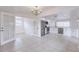 Open-concept dining area adjacent to a modern kitchen, featuring tile flooring and ample natural light at 3129 Buttonwood Pl, Punta Gorda, FL 33950