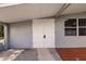Home's front entrance features double doors and a small window; a covered area protects from the elements at 3129 Buttonwood Pl, Punta Gorda, FL 33950