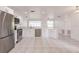 Contemporary kitchen featuring stainless steel appliances, white cabinetry, and an open layout with tile flooring throughout at 3129 Buttonwood Pl, Punta Gorda, FL 33950