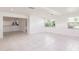 Living room featuring neutral walls, tile flooring, and ample natural light from large windows at 3129 Buttonwood Pl, Punta Gorda, FL 33950