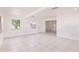Living room featuring neutral walls, tile flooring, and ample natural light from large windows at 3129 Buttonwood Pl, Punta Gorda, FL 33950
