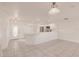 Bright, open-concept living space featuring tile flooring, white walls, and a modern kitchen with stainless steel appliances at 3129 Buttonwood Pl, Punta Gorda, FL 33950