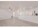 Spacious living room with sleek tile flooring, neutral walls, and an open view into the modern kitchen area at 3129 Buttonwood Pl, Punta Gorda, FL 33950