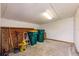 Utility room with exposed ceiling and a fluorescent light fixture; lots of floor space for storage at 3129 Buttonwood Pl, Punta Gorda, FL 33950