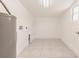 Utility room features neutral walls, sleek tile flooring, and a water heater for added convenience at 3129 Buttonwood Pl, Punta Gorda, FL 33950