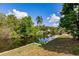 Scenic waterfront view featuring lush tropical vegetation and a private dock at 3129 Buttonwood Pl, Punta Gorda, FL 33950