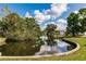 Picturesque waterfront view showcases a calm canal with mature trees and private boat dock at 3129 Buttonwood Pl, Punta Gorda, FL 33950
