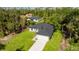 Bright single-Gathering home is surrounded by lush landscaping, featuring a private driveway at 355 Milton St, Port Charlotte, FL 33954