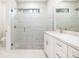 Modern bathroom featuring tiled walls, a glass shower, and a vanity with a quartz countertop at 355 Milton St, Port Charlotte, FL 33954