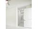 Bright bedroom featuring a ceiling fan and tile flooring, leading to a closet and bathroom at 355 Milton St, Port Charlotte, FL 33954