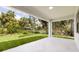 Covered patio with a view of a lush green lawn and tropical landscaping at 355 Milton St, Port Charlotte, FL 33954