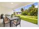 Covered patio with an outdoor dining set and a view of the landscaped yard at 355 Milton St, Port Charlotte, FL 33954