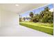 Back patio offering views of the expansive backyard and tropical landscaping at 355 Milton St, Port Charlotte, FL 33954