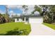 Beautiful one-story home featuring a well-manicured front yard and a two-car garage at 355 Milton St, Port Charlotte, FL 33954