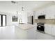 Stylish kitchen featuring a large island with white countertops, stainless steel appliances and elegant pendant lighting at 355 Milton St, Port Charlotte, FL 33954