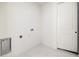 Bright laundry room featuring a white door and tile flooring at 355 Milton St, Port Charlotte, FL 33954