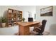 Home office features built in shelves, desk, rolling chair, and natural light from the window at 355 Milton St, Port Charlotte, FL 33954