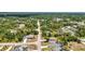 Enjoy this aerial view of a neighborhood with a mix of charming homes surrounded by lush trees at 3799 Laredo Ave, North Port, FL 34288