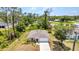 An aerial view of a cozy single-Gathering home surrounded by lush greenery and mature trees at 3799 Laredo Ave, North Port, FL 34288