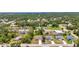 A high up look at the property surrounded by a vibrant, wooded suburban area and local amenities at 3799 Laredo Ave, North Port, FL 34288