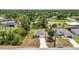 Aerial view shows the home nestled in a vibrant neighborhood with lush trees and proximity to local amenities at 3799 Laredo Ave, North Port, FL 34288