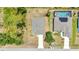 An aerial shot showing the house with a driveway and nearby home with a screened-in pool at 3799 Laredo Ave, North Port, FL 34288