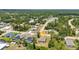 A drone shot highlights the home's setting in a mature, green neighborhood with beautiful landscape at 3799 Laredo Ave, North Port, FL 34288