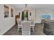 Chic dining room showcasing a rustic table setting, chandelier lighting, and stylish wood-look flooring at 3799 Laredo Ave, North Port, FL 34288