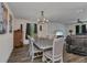 Elegant dining room featuring a rustic table, a chandelier, and wood-look flooring for a warm ambiance at 3799 Laredo Ave, North Port, FL 34288