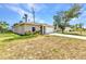 Charming single-story home with a beige exterior and a well-maintained lawn and inviting, covered entrance at 3799 Laredo Ave, North Port, FL 34288