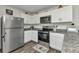 Kitchen featuring stainless steel appliances, granite countertops, and hardwood flooring at 3799 Laredo Ave, North Port, FL 34288