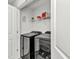 Efficient laundry room with modern washer and dryer units, maximizing space with storage shelving at 3799 Laredo Ave, North Port, FL 34288