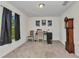Well-lit office showcasing neutral carpeting, a window with curtains, and a vintage grandfather clock at 3799 Laredo Ave, North Port, FL 34288