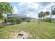 Spacious backyard showcases the enclosed pool area with beautiful mature landscaping at 4055 Alwick Ln, North Port, FL 34287