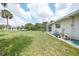 Lush green yard featuring mature trees and the enclosed pool, providing a serene outdoor retreat at 4055 Alwick Ln, North Port, FL 34287