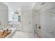 Bright bathroom with a large mirror, dual sinks, and a tub-shower combo at 4055 Alwick Ln, North Port, FL 34287