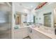 Bathroom featuring dual sinks, a large mirror, with a walk in shower and lots of natural light at 4055 Alwick Ln, North Port, FL 34287