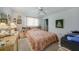 Cozy bedroom with a bed and dresser, with art on the wall and a ceiling fan at 4055 Alwick Ln, North Port, FL 34287
