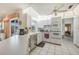 Bright kitchen featuring white cabinetry, tile flooring, and modern appliances with an eat-in counter at 4055 Alwick Ln, North Port, FL 34287