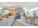 Open concept kitchen featuring white cabinetry, a breakfast bar and eat in desk, and access to the screened porch at 4055 Alwick Ln, North Port, FL 34287