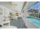 Enclosed patio boasts an in-ground pool, ceiling fans, and dining area for relaxed outdoor living at 4055 Alwick Ln, North Port, FL 34287
