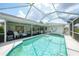 A covered pool area with clear blue water and lounge seating provides a relaxing outdoor experience at 4055 Alwick Ln, North Port, FL 34287